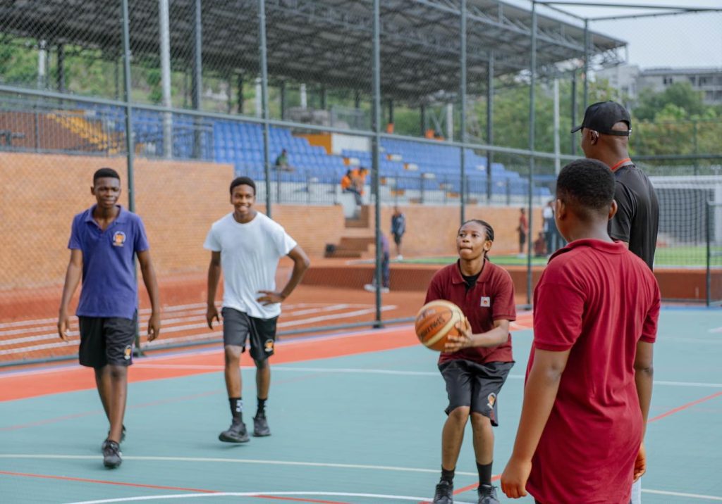 Student playing basketball at Jewels Leading Light's basketball court